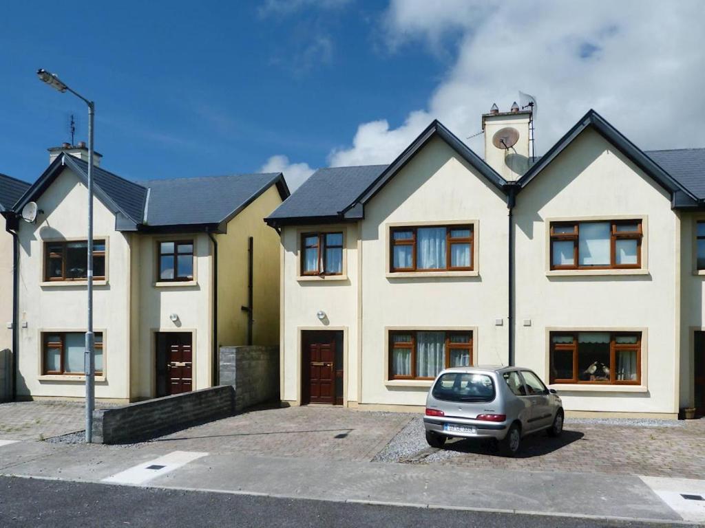 a white house with a car parked in front of it at 3 Bed in Ennistimon oc-ii08862 in Ennistymon