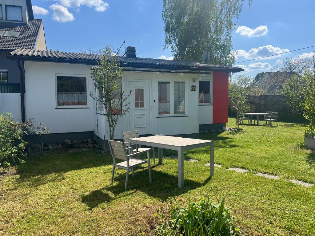 a table and a chair in front of a house at Casa Lauda in Pillichsdorf in Pillichsdorf