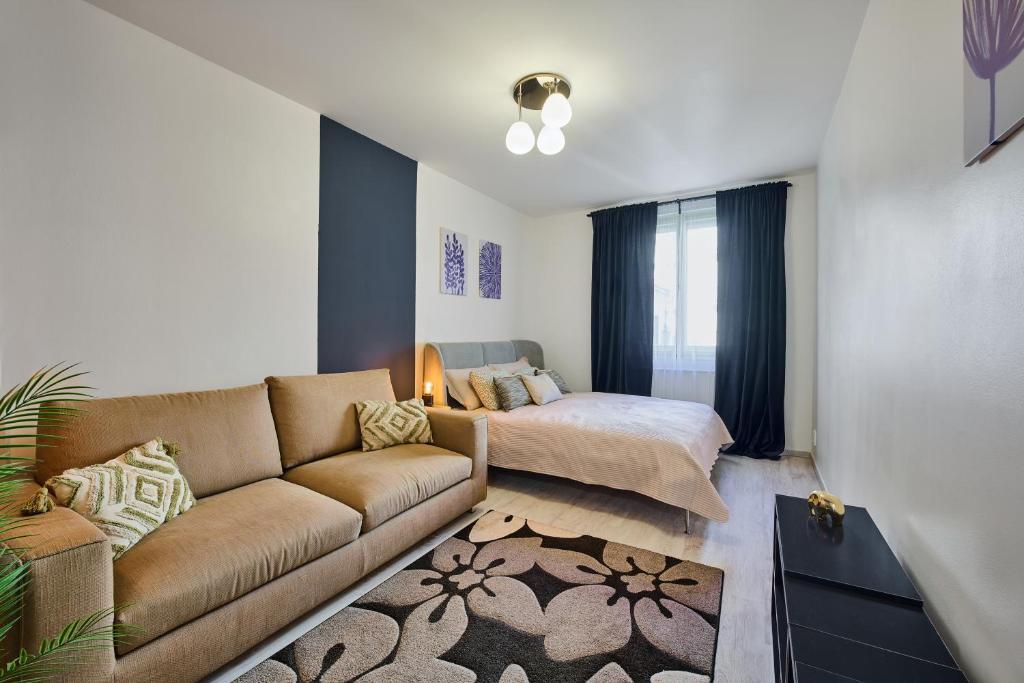 a living room with a couch and a bed at Apartment Mostecka in Prague