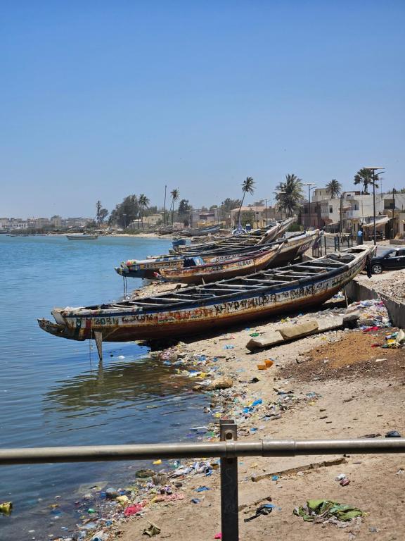 a group of boats parked on the shore of a beach at Villa Shérazade in Saint-Louis