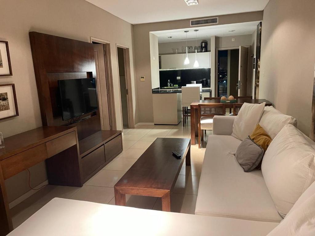 a living room with a white couch and a table at CONDOMINIOS DE BAHIA GRANDE NORDELTA!! Tigre in Tigre