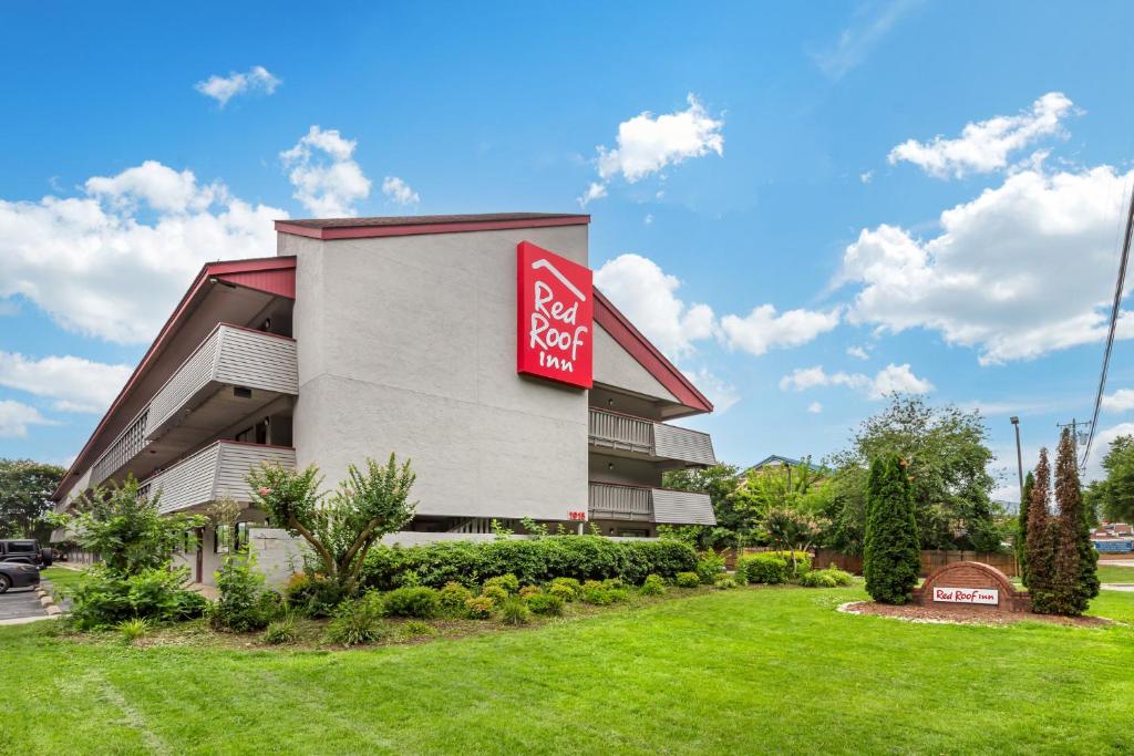 a building with a red sign on the side of it at Red Roof Inn Durham - Duke Univ Medical Center in Durham