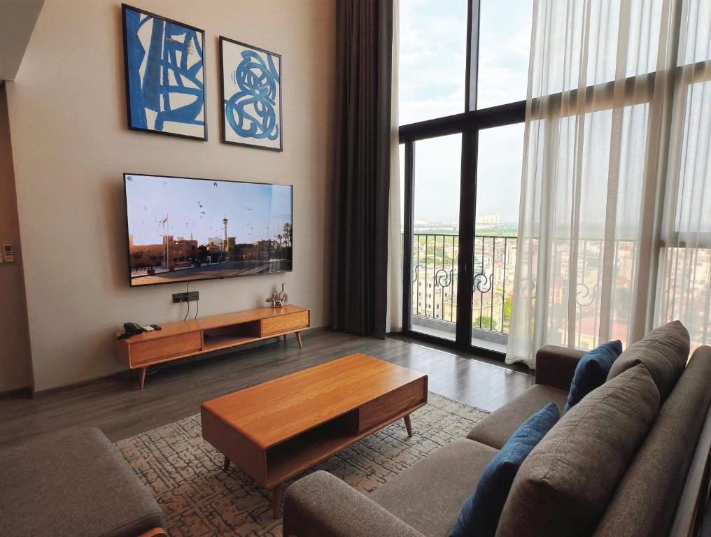 a living room with a couch and a flat screen tv at Westlake view condominium in Hanoi