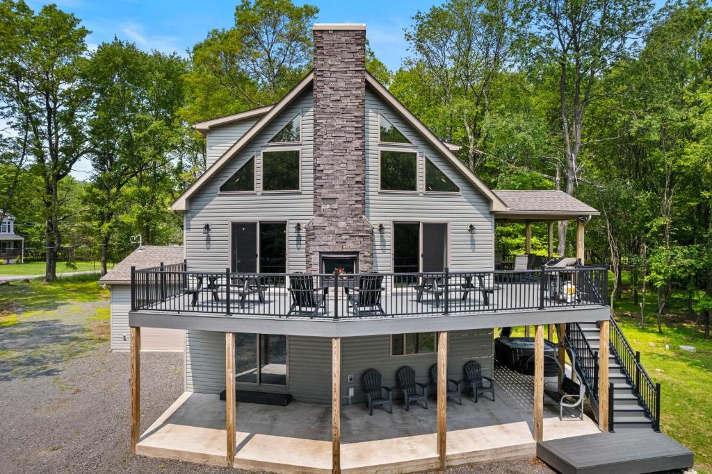 a house with a wrap around porch with a wrap around deck at Hot Tub and Community Beach Albrightsville Home! in Albrightsville