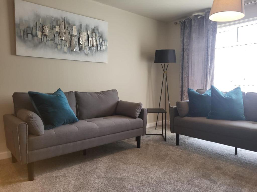 a living room with two couches and a window at The MacIntyre - Coorie Doon Stays in Kilmarnock