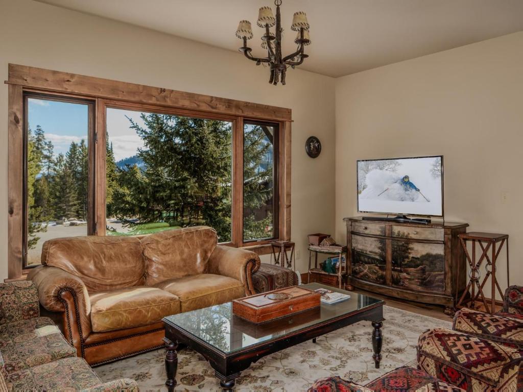 a living room with a couch and a table at Twin Lift Lodge in Big Sky Mountain Village