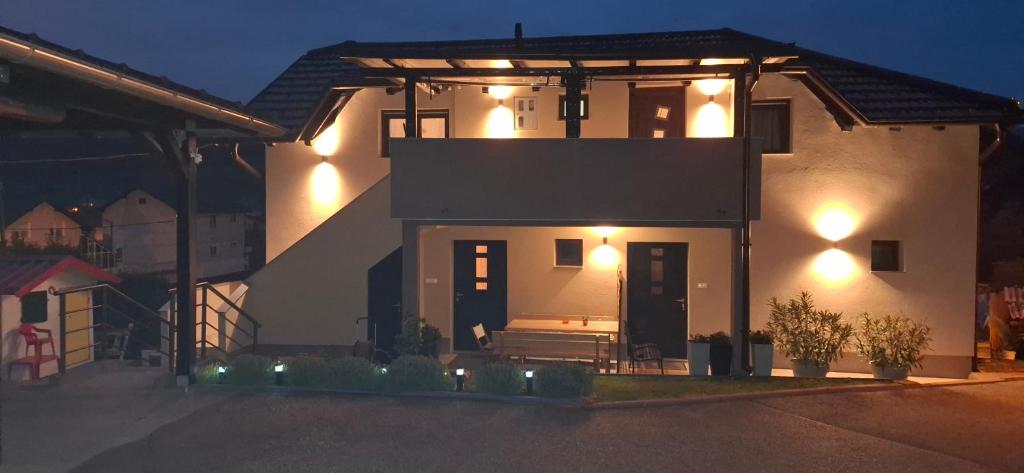 a house with lights on the side of it at night at Apartman Folka free parking in Zagreb