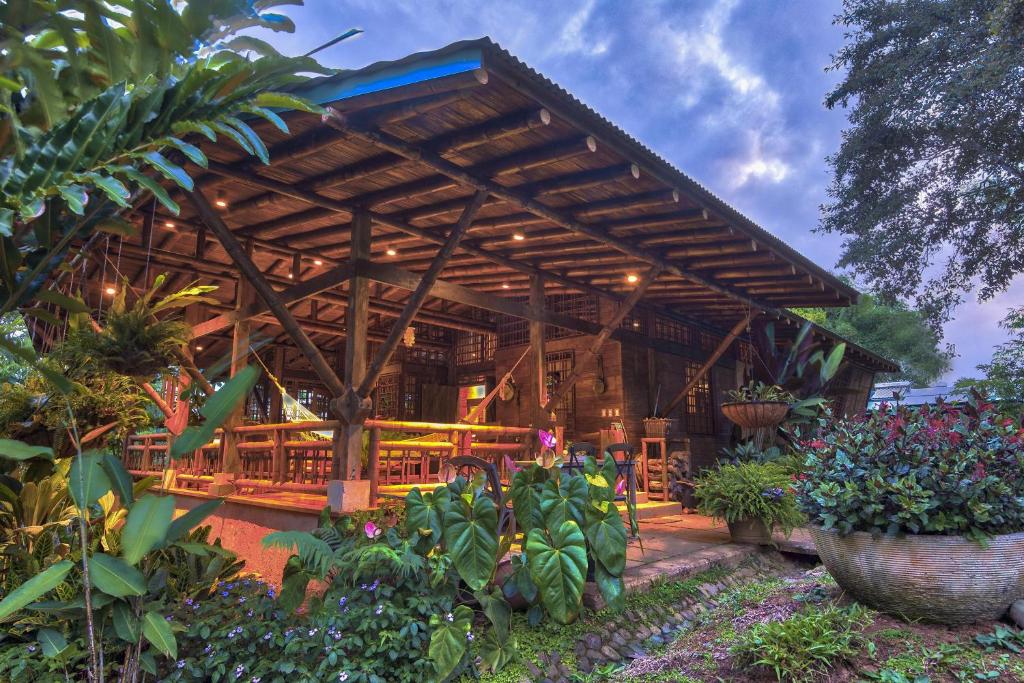 a large wooden building with tables and plants at Casa Alma, Nature Escape with River, Trails and Views in San Rafael