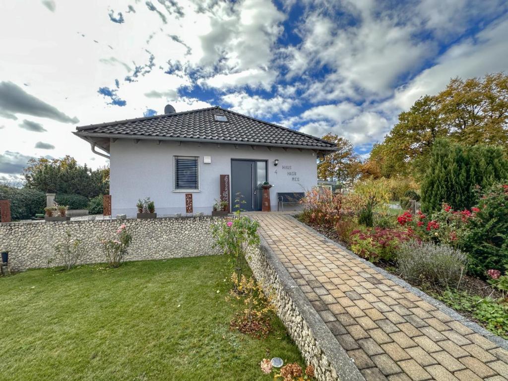 a white house with a brick walkway at Hasn Res in Kleinwinklarn