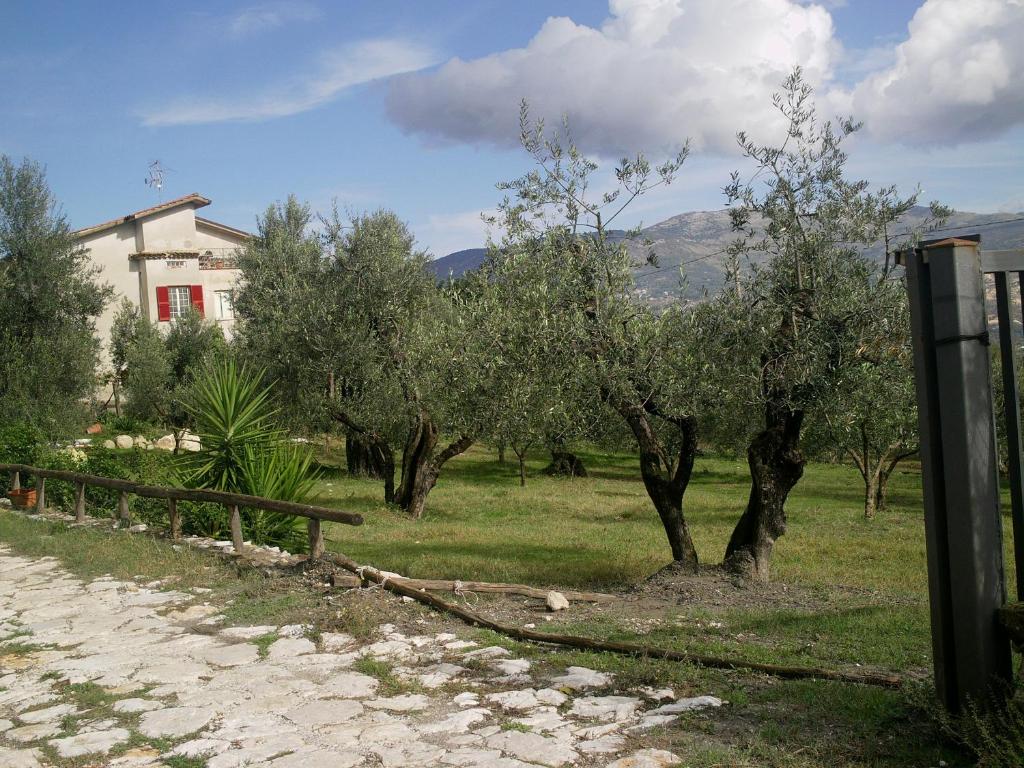 a field with trees and a house and a fence at B&B Da Mariella in Spigno Saturnia