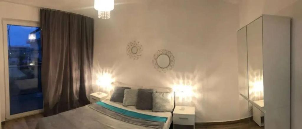 Un dormitorio con una cama grande y una ventana grande. en Piastowskie Apartments, en Poznan