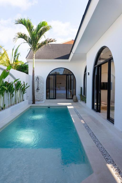 a swimming pool in the backyard of a house at VILLA DAHO Mediterranean Elegance in Ungasan
