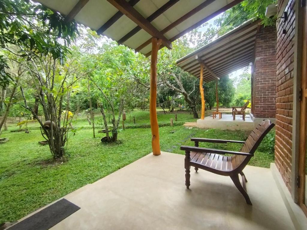 a bench sitting under a pavilion in a park at Wilpattu Wild Villa in Pahala Maragahawewa
