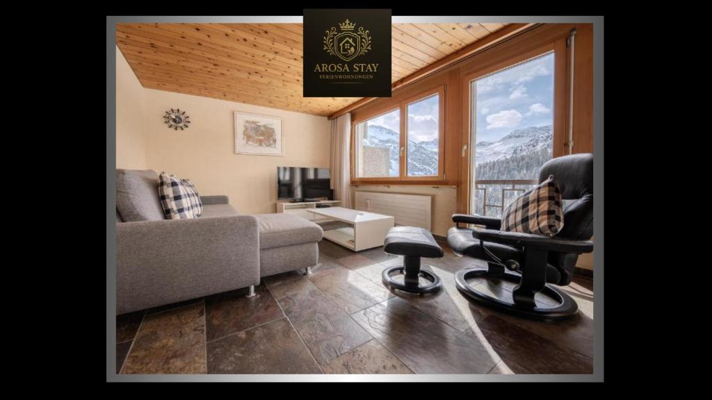 a living room with a couch and a chair at Villa Franca E07 by Arosa Stay in Arosa