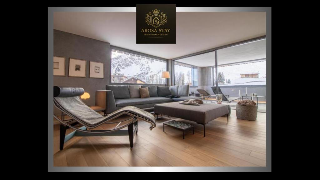 a living room with a couch and a chair at Alpin Panorama Suite by Arosa Stay in Arosa