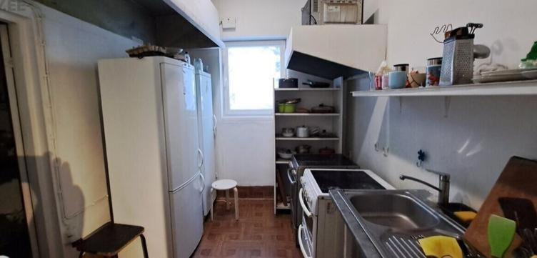 a small kitchen with a sink and a refrigerator at Artishalico tallinn in Tallinn