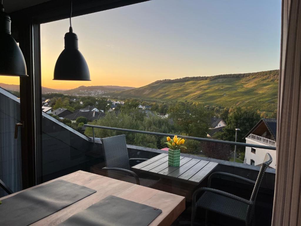 a balcony with a table and chairs and a view at HTS Mosel Apartment Wanderlust Bernkastel Andel in Bernkastel-Kues