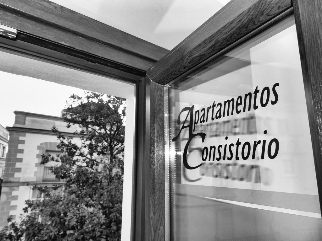 a window of a store with a sign on it at Apartamentos Consistorio Live in Jerez de la Frontera