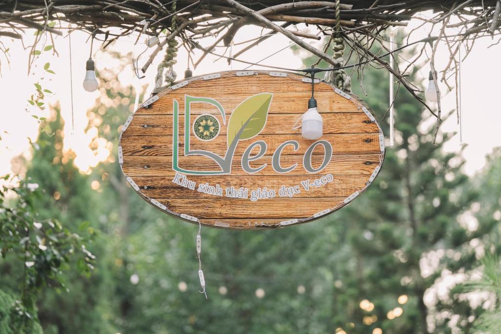 a sign that says eco hanging from a tree at V-Eco Nest in Thạch Cầu