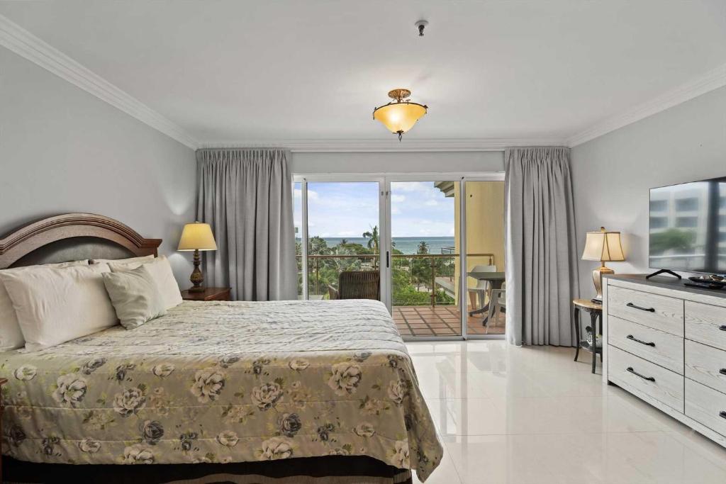 a bedroom with a bed and a view of the ocean at Beachfront - Best Beach View Studio - E422-1 in Palm-Eagle Beach