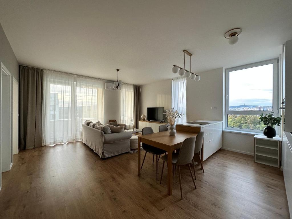 a living room with a table and a couch at Labutia, self-checkin, parking, AC in Bratislava