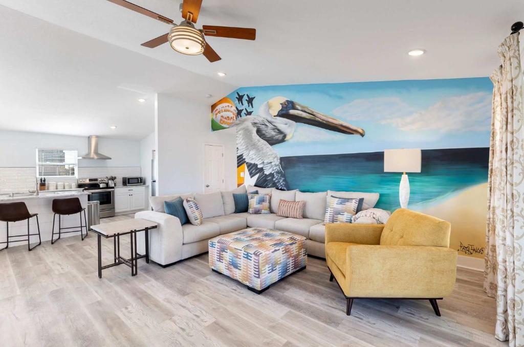 a living room with a couch and a painting at Blue Beak Bungalow in Pensacola