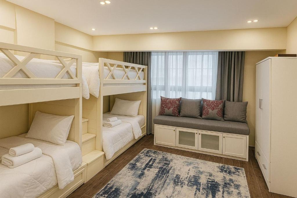 a small room with bunk beds and a window at Charming Apartment - Near Cairo Airport in Cairo