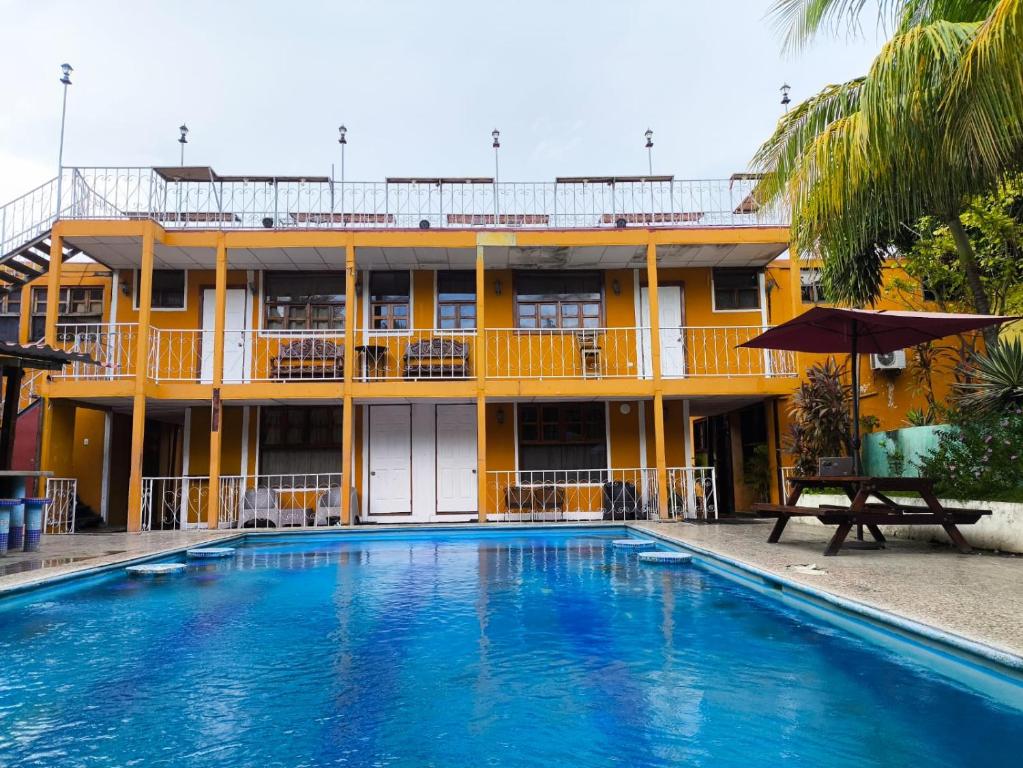 a hotel with a swimming pool in front of a building at Hotel Corazon de Granada in Granada