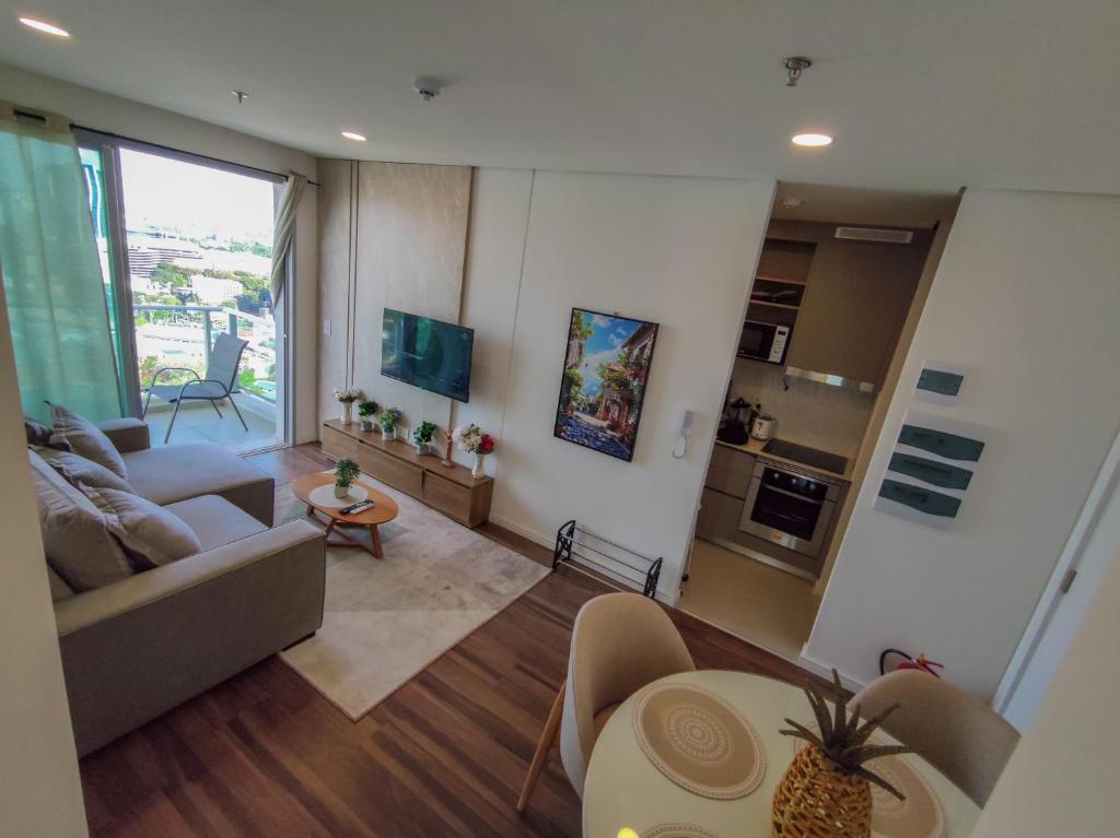 a living room with a couch and a table at Luxury 2 Bedroom "Wake Up in the Sky" Best Views & Location in Asuncion in Asuncion