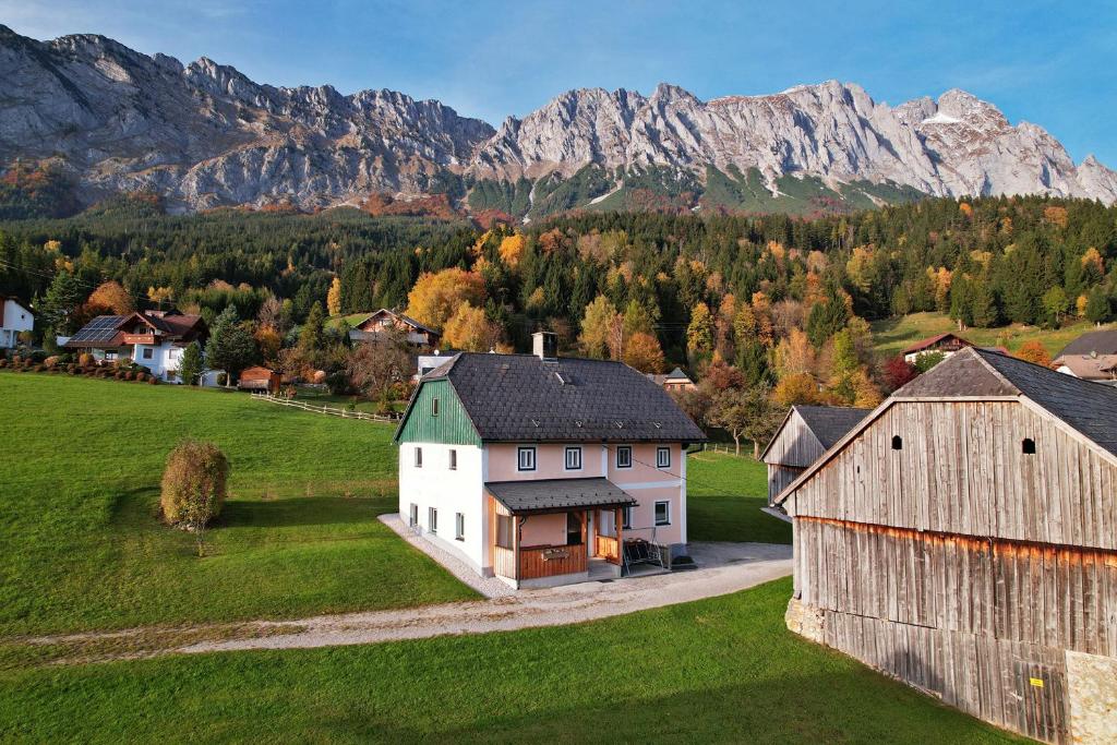 an aerial view of a farm with mountains in the background at Ferienhaus Schwöllerbauer in Sankt Martin am Grimming
