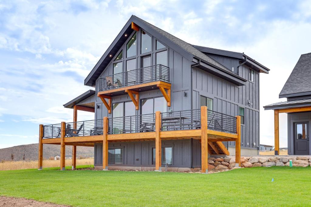 a house with a large deck on the side of it at Mtn and Lake Views Family Retreat in Garden City! in Garden City