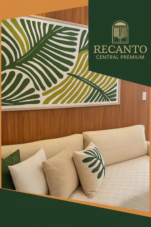 a couch with pillows in a room with a poster at Recanto Central Premium in Vitória da Conquista
