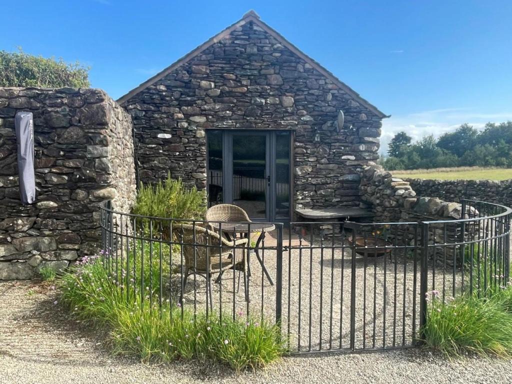 a stone house with a gate in front of it at 1 Bed in Ullswater 94064 in Watermillock
