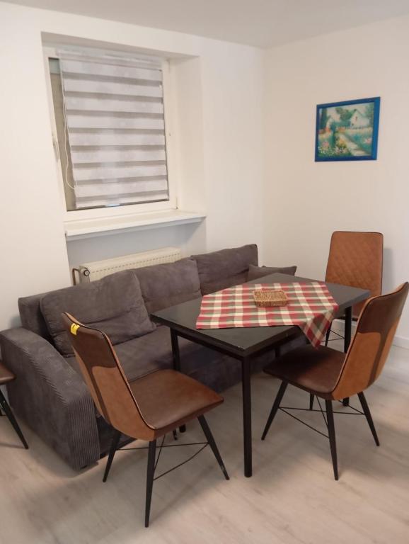 a living room with a couch and a table with chairs at Teuchern in Teuchern