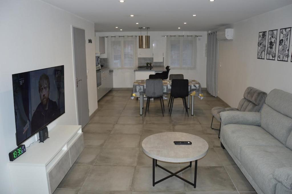 a living room with a couch and a table at Logement 4 personnes Sainte-Florine in Sainte-Florine