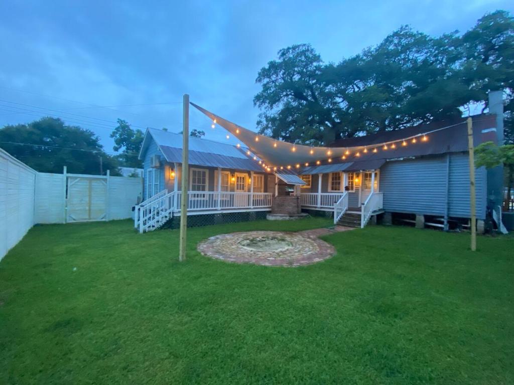 a backyard with a house with a string of lights at Courtyard by Ravens Keep in Jackson