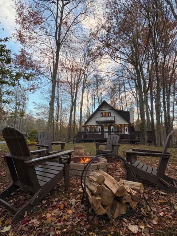 a group of chairs and a fire pit in front of a house at Walking Distance to the Beach Cabin with AC in Arrowhead Lake