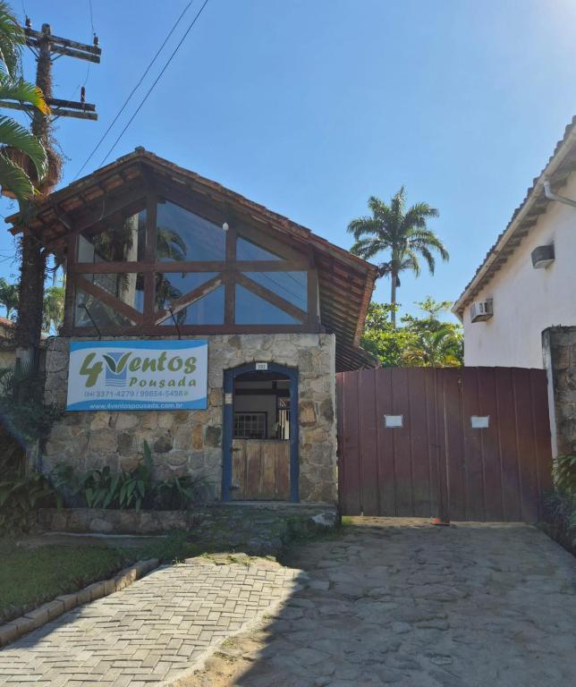 a house with a sign on the front of it at 4 Ventos Pousada in Paraty