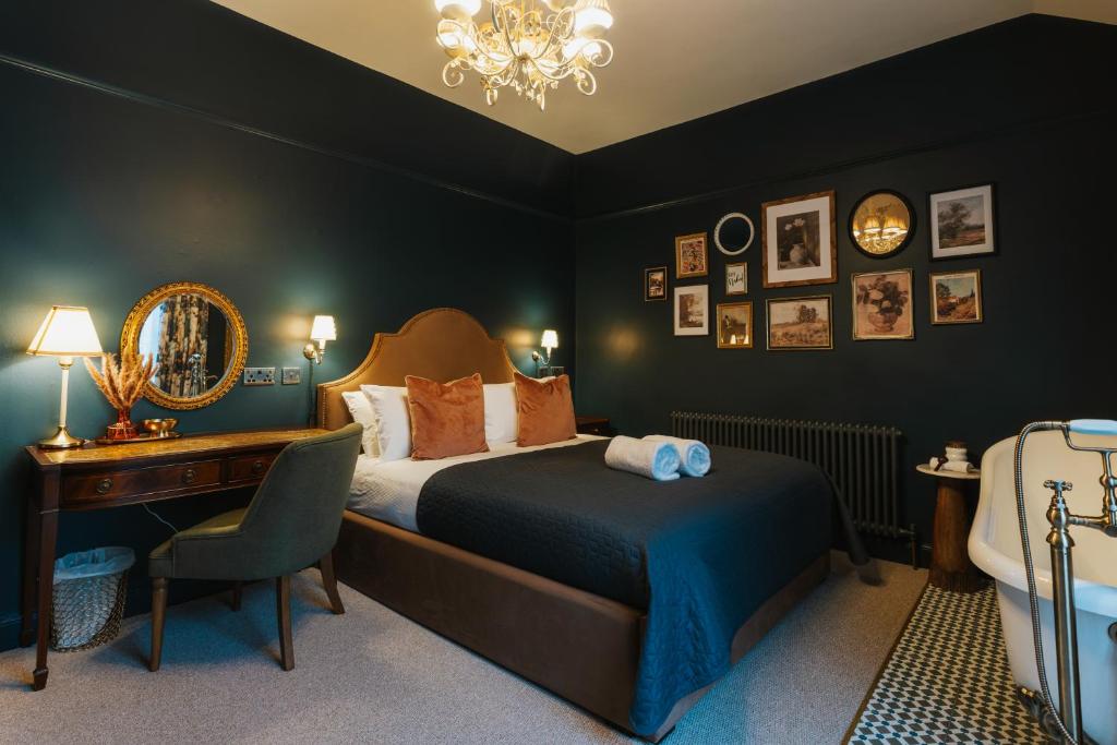 a bedroom with a bed and a desk and a chair at Bishy Hill Town House in York in York