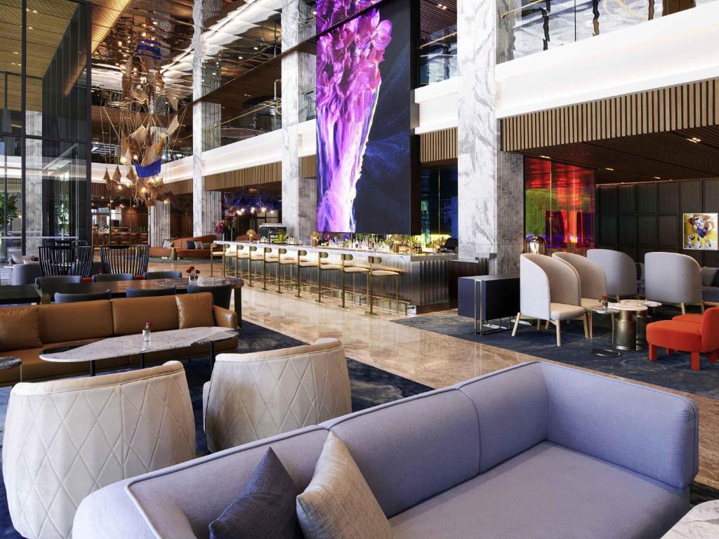 a lobby with couches and a bar in a building at Mondrian Seoul Itaewon in Seoul