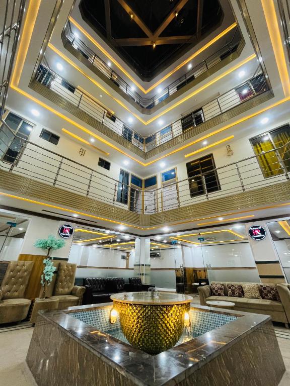 a lobby with a large table in the middle at HR Guest House in Gilgit