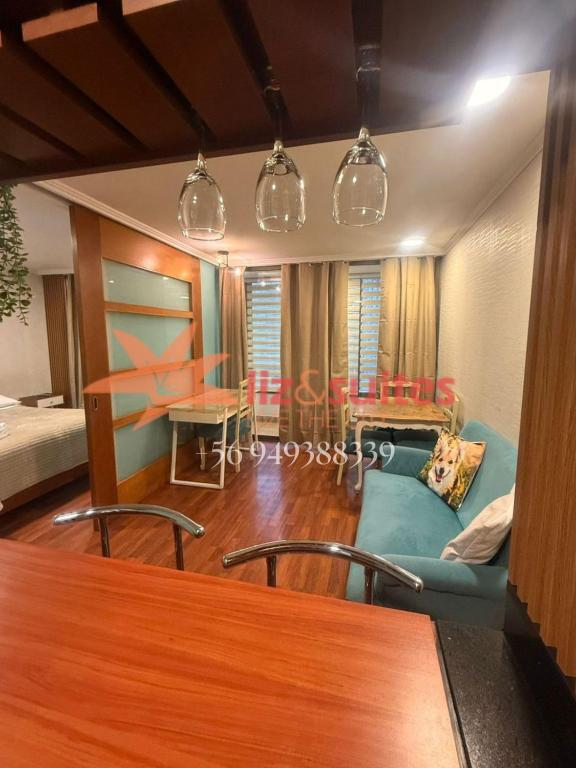 a living room with a couch and a table at Liz Suites departamentos Manuel Montt in Santiago