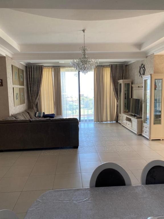 a large living room with a couch and a television at Коттедж - Вилла in Chok-Tal