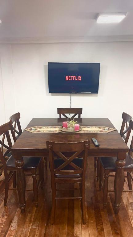 a wooden table with chairs and a sign that reads netflix at Valparaiso's Best in Valparaíso