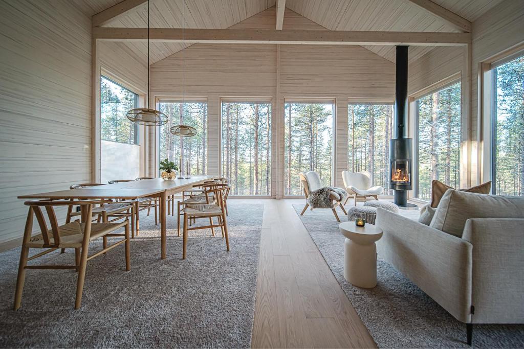 a living room with a table and a couch at Arctic Design Villa Levi in Levi