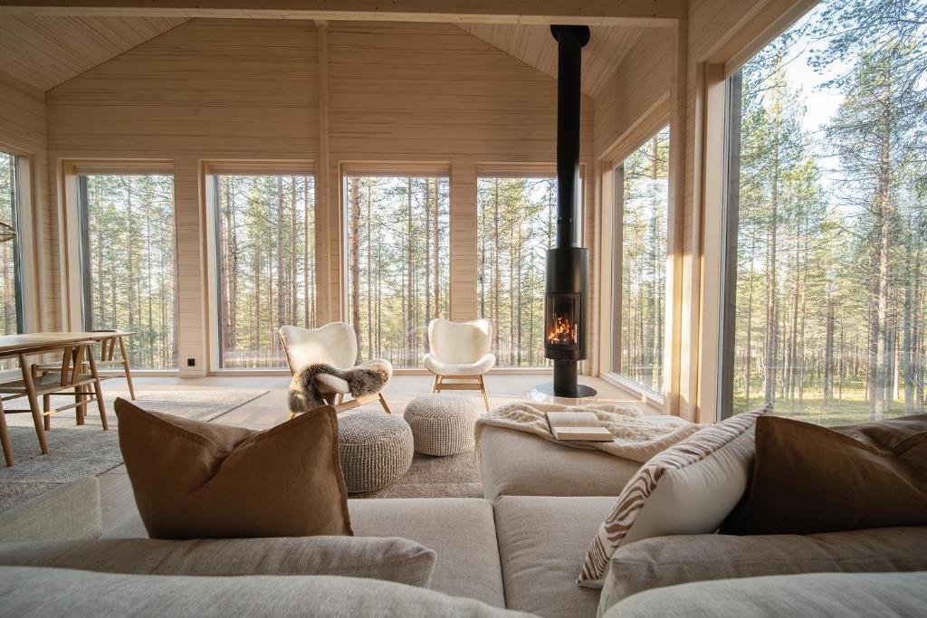 a living room with a couch and a fireplace at Arctic Design Villa Levi in Levi