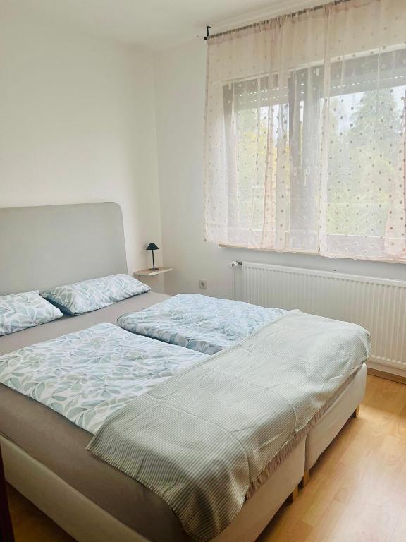 ein Schlafzimmer mit zwei Betten und einem Fenster in der Unterkunft Alari Loft in Korbach