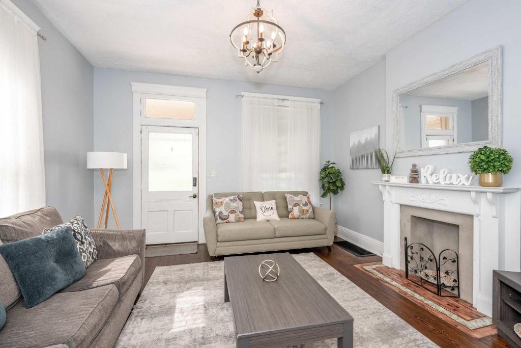 a living room with a couch and a fireplace at Queen City Suites 1 - For 3 in Cincinnati
