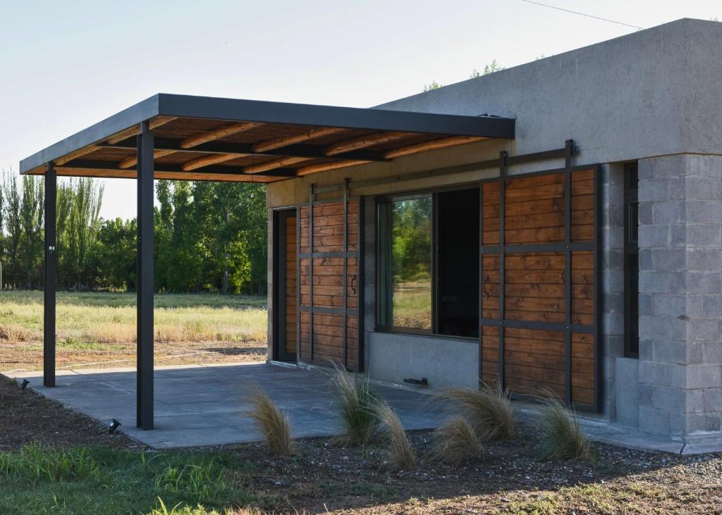 a small building with a roof on a field at Mahuida Lodge Valle de Uco in Colonia Las Rosas