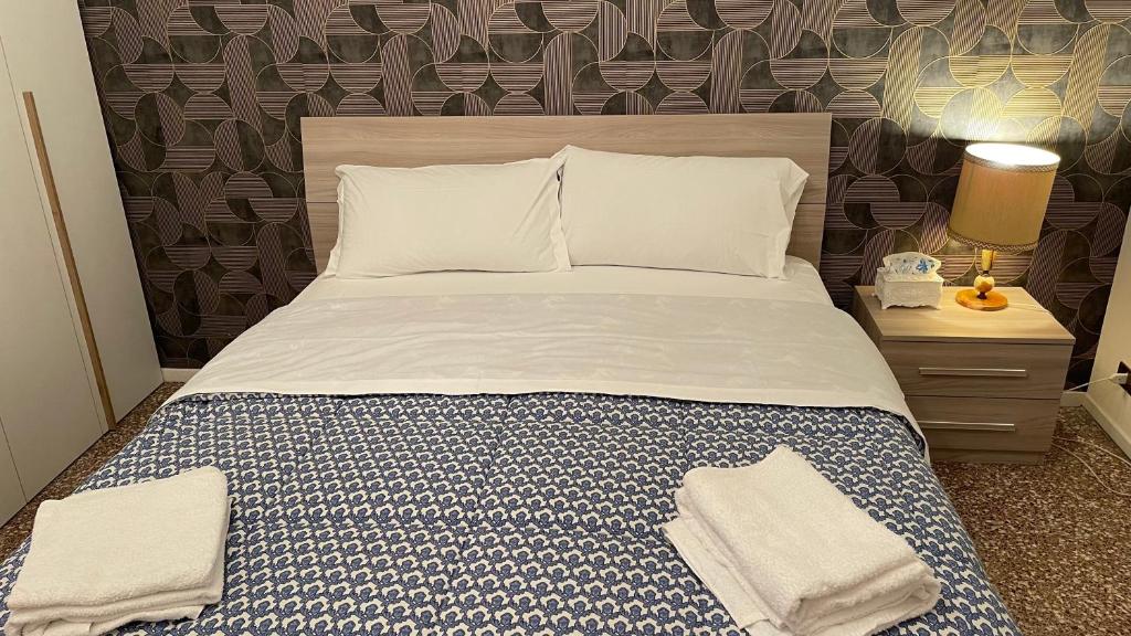 a bedroom with a bed with two towels on it at Casa Amore a Bergamo in Bergamo